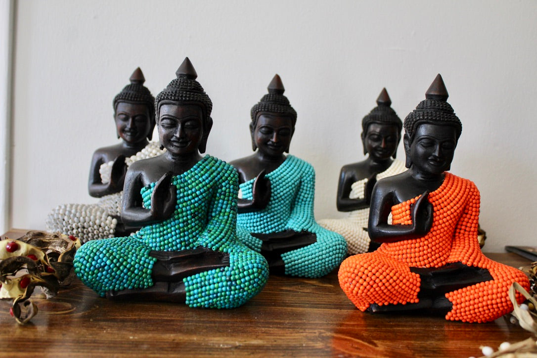 buddha statue Protecting Buddha ,wood, wearing turquoise stones painted orange. He is 8 inches height and 6 inches width at knees.